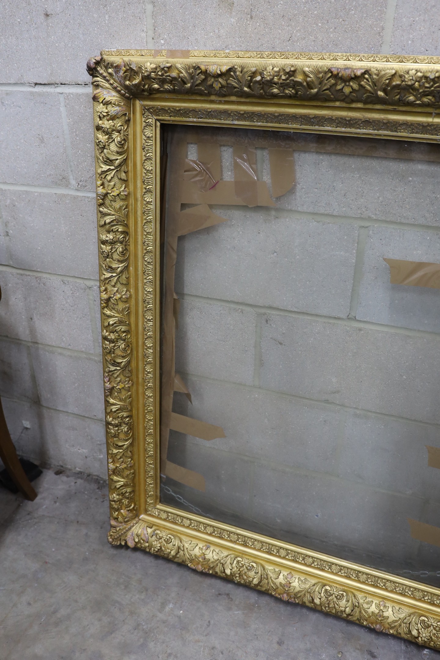 A Victorian rectangular giltwood and gesso picture frame, aperture 75 x 96 cms.